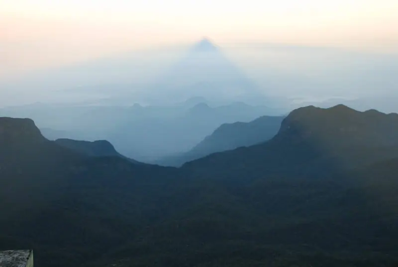 The triangular shadow of Sri Pada (Adam's Peak) cast over the hills at sunrise