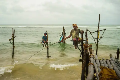 Stilt fishermen at work off the shore at Ahangama