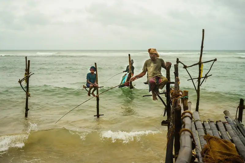 Stilt fishermen at work off the shore at Ahangama