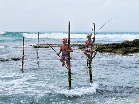 Stilt fishing poles on the rocky shore near Ahangama