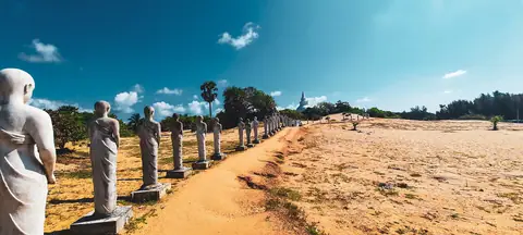 Ancient statues lined up beside the beach at Muhudu Maha Vihara, Pottuvil