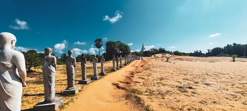 Ancient statues lined up beside the beach at Muhudu Maha Vihara, Pottuvil