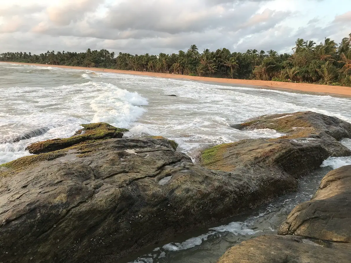 Waves breaking on the rocks at Bentota beach in the evening