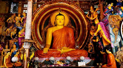 The golden seated Buddha inside Gangaramaya Temple, Colombo