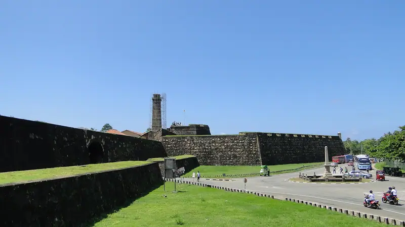 The grassy ramparts of Galle Fort with the clock tower behind