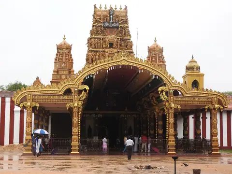 The golden gateway and red tower of Nallur Kandaswamy Kovil, Jaffna