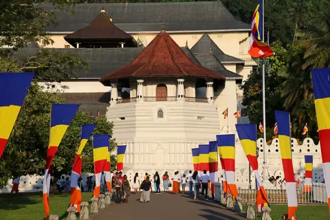 Buddhist flags lining the approach to the Paththirippuwa, the octagon of the Temple of the Tooth