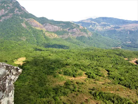 Green slopes and rock faces in the Knuckles Mountain Range