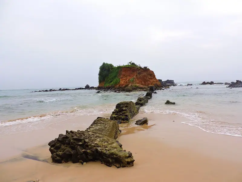 Parrot Rock at the end of the reef on Mirissa beach