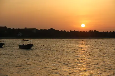 Fishing boats at sunset off Pasikudah beach