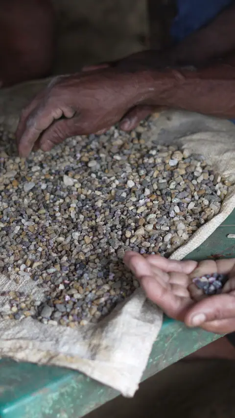 Washed gem gravel being sorted by hand at a gem pit near Pelmadulla