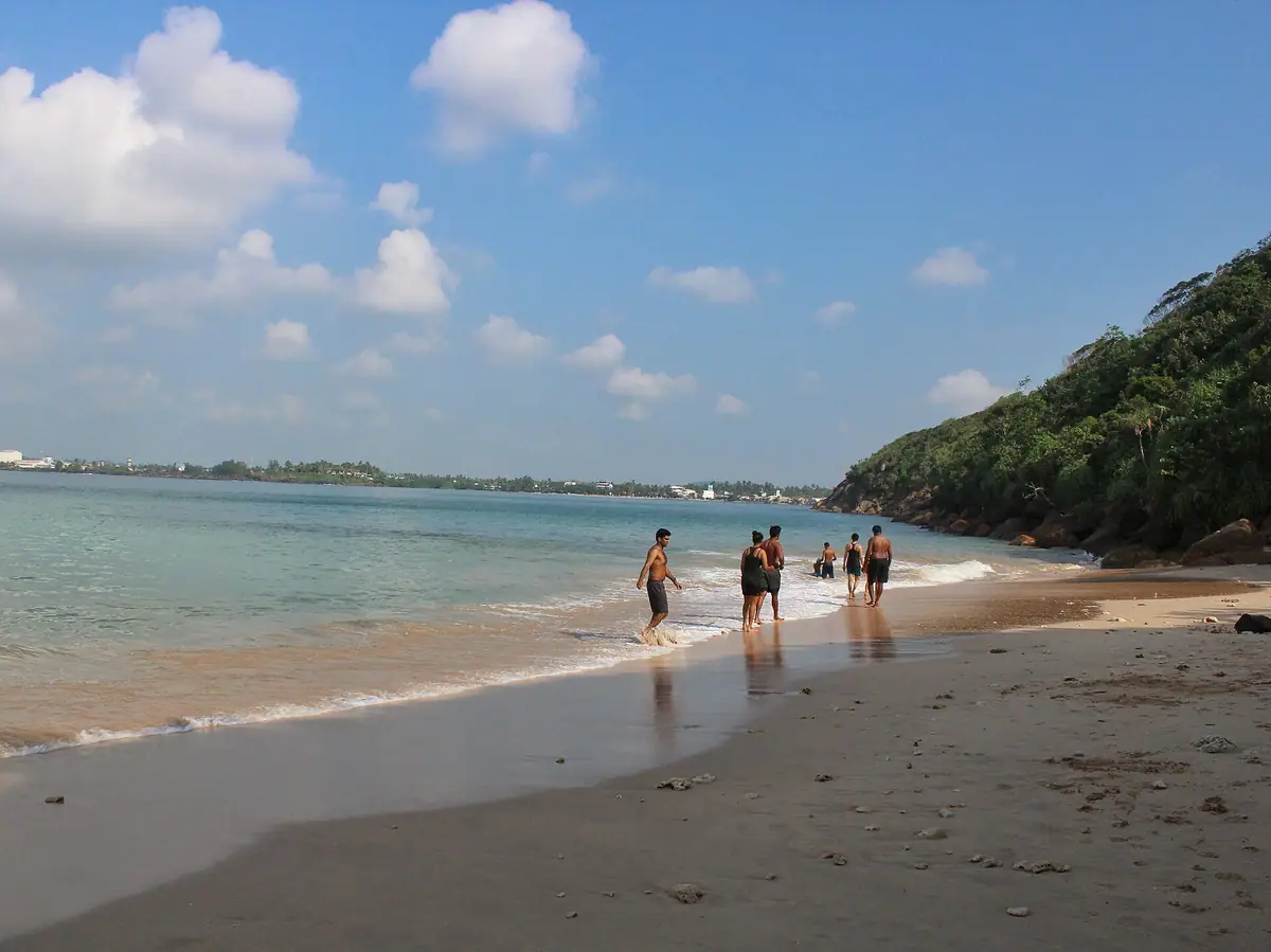 Swimmers in the shallow water at Jungle Beach, Unawatuna