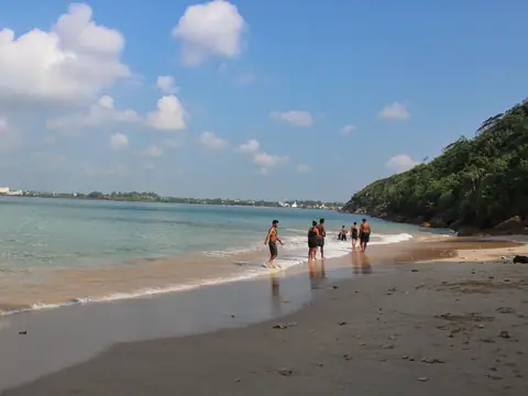 Swimmers in the shallow water at Jungle Beach, Unawatuna