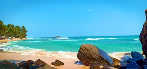 Waves on the white sand at Dalawella beach