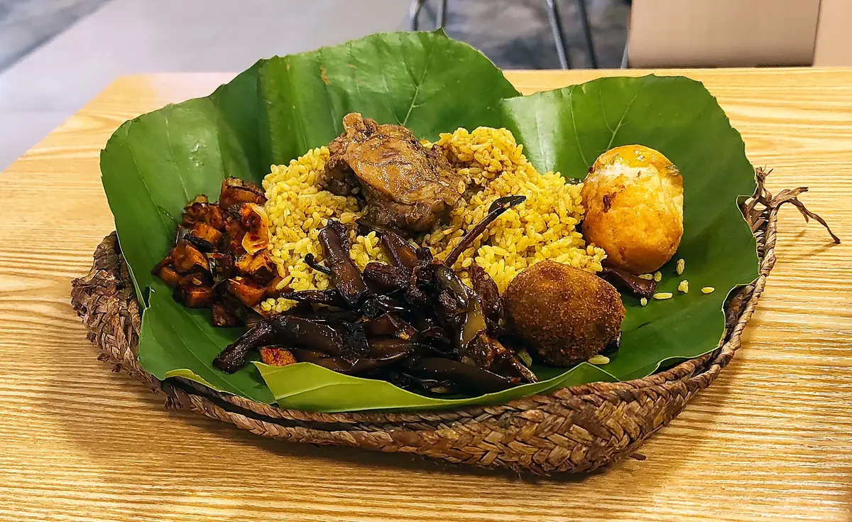 Lamprais: rice, curries and a frikkadel wrapped in a banana leaf