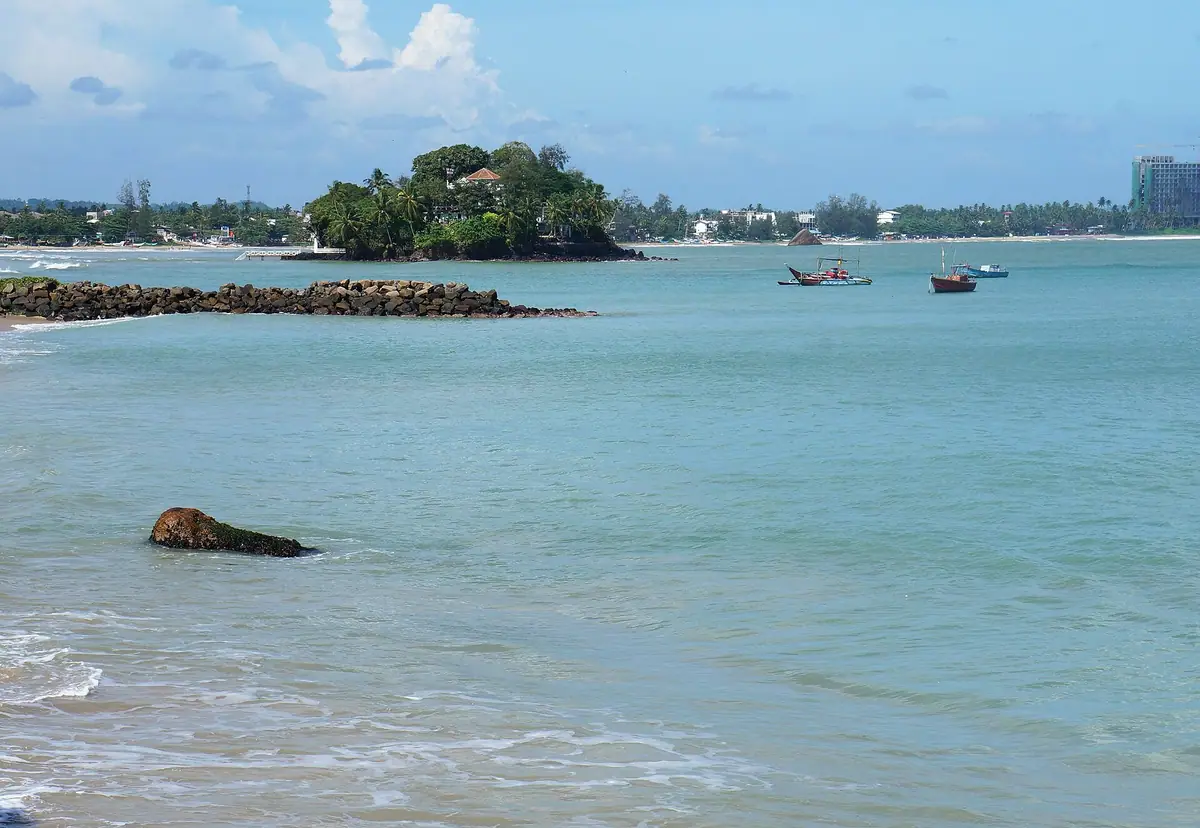 Calm water in Weligama Bay with the small island offshore